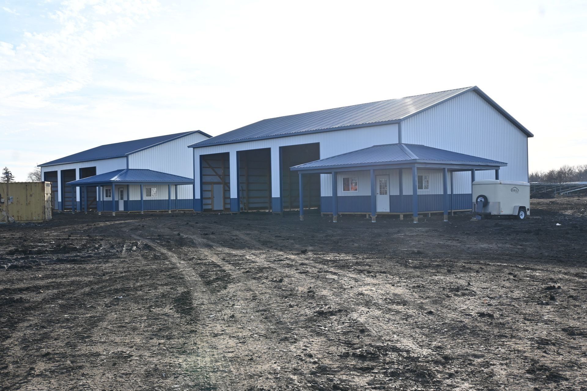 Multi-bay post-frame building with a lean-to porch